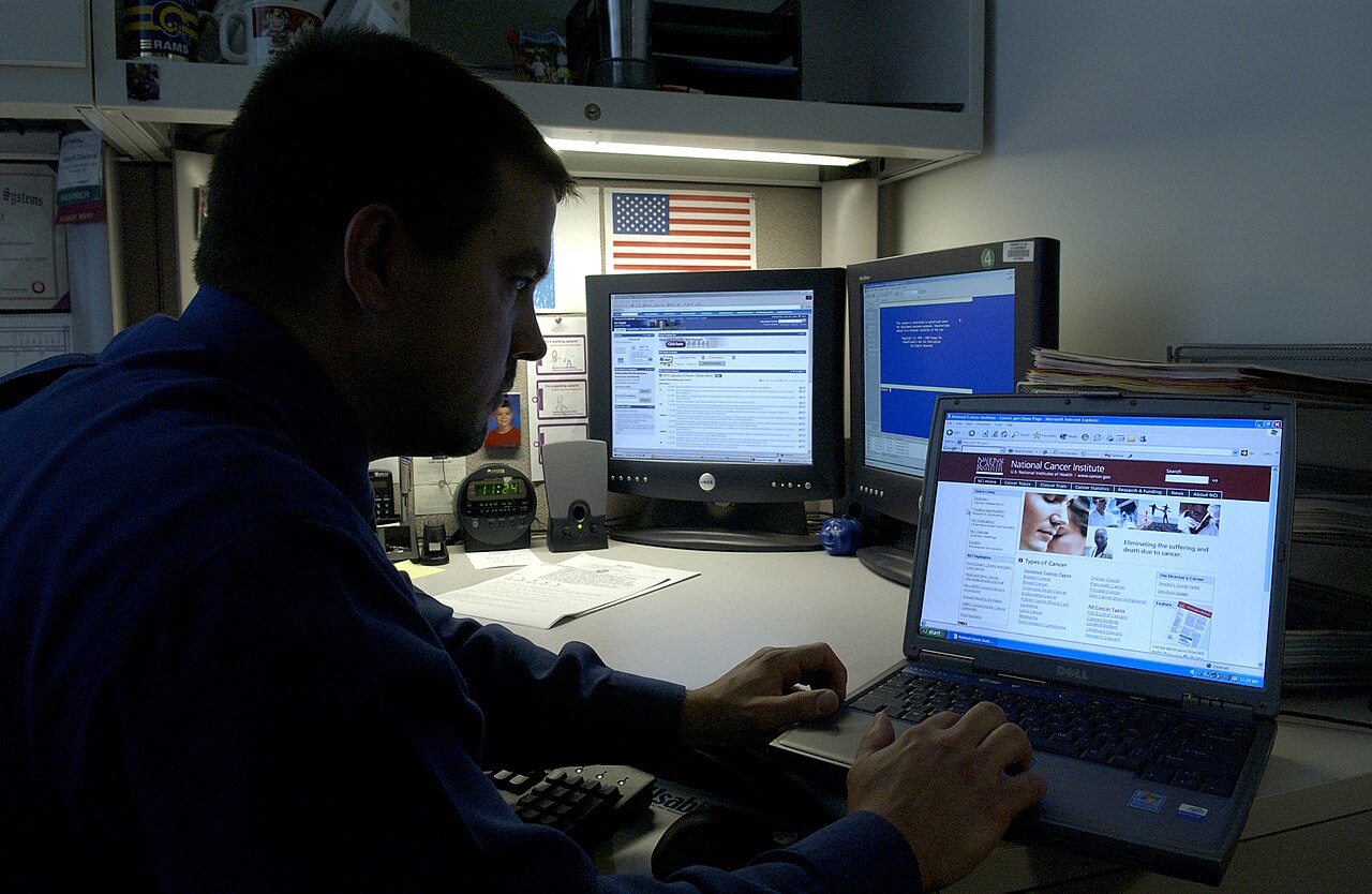 A person using a laptop to manage money with AI tools